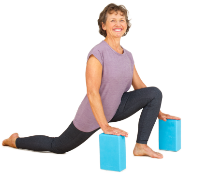 Margaret in a yoga pose with two blocks under her hands
